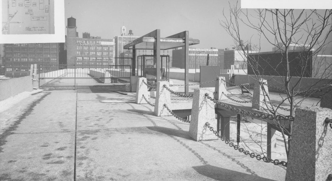 Historical photo of pedestrian bridge over UIC Circle Campus with brick factories visible in the distance.